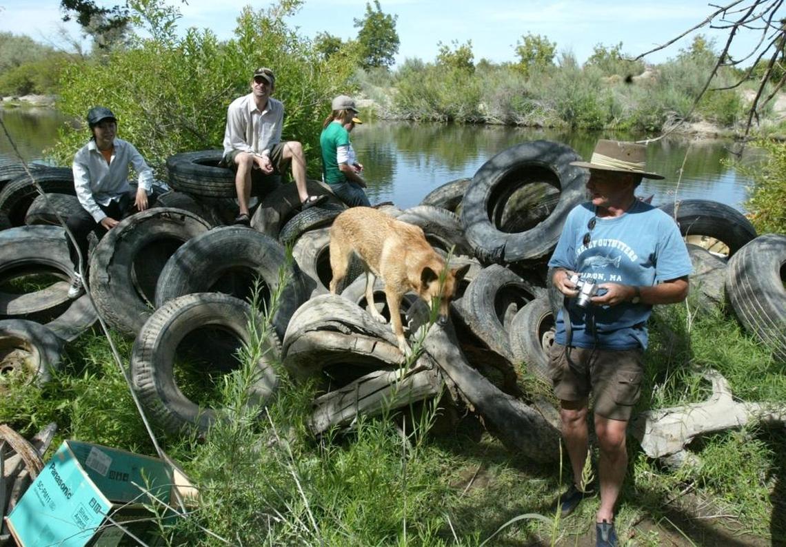 Richard Sloan, co-founder of RiverTree Volunteers, stands next to a pile of illegally dumped tires that he and other volunteers removed from the San Joaquin River during a 2005 cleanup effort. Volunteers pulled more than 11,000 tires from the river.