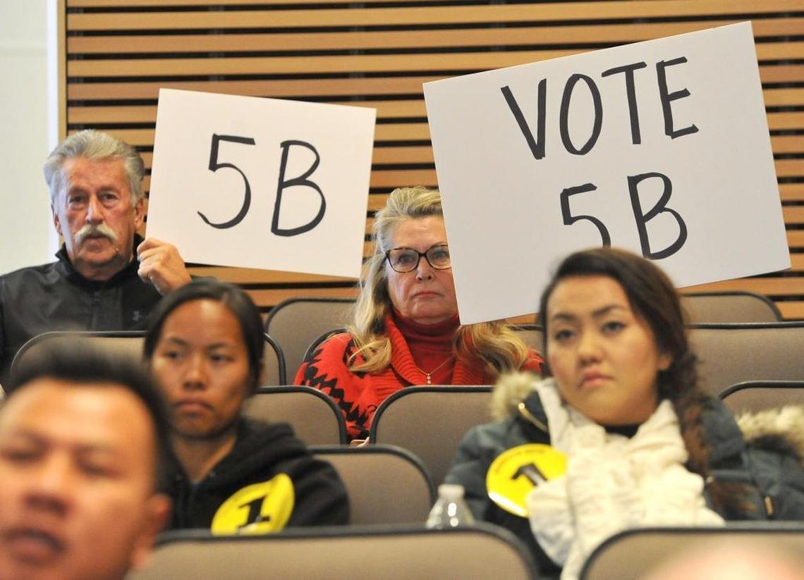 Husband and wife Bill and Marlene Youpel show their support for Alternative 5B during Wednesday’s San Joaquin River Conservancy board meeting at the Clovis Veterans Memorial District.