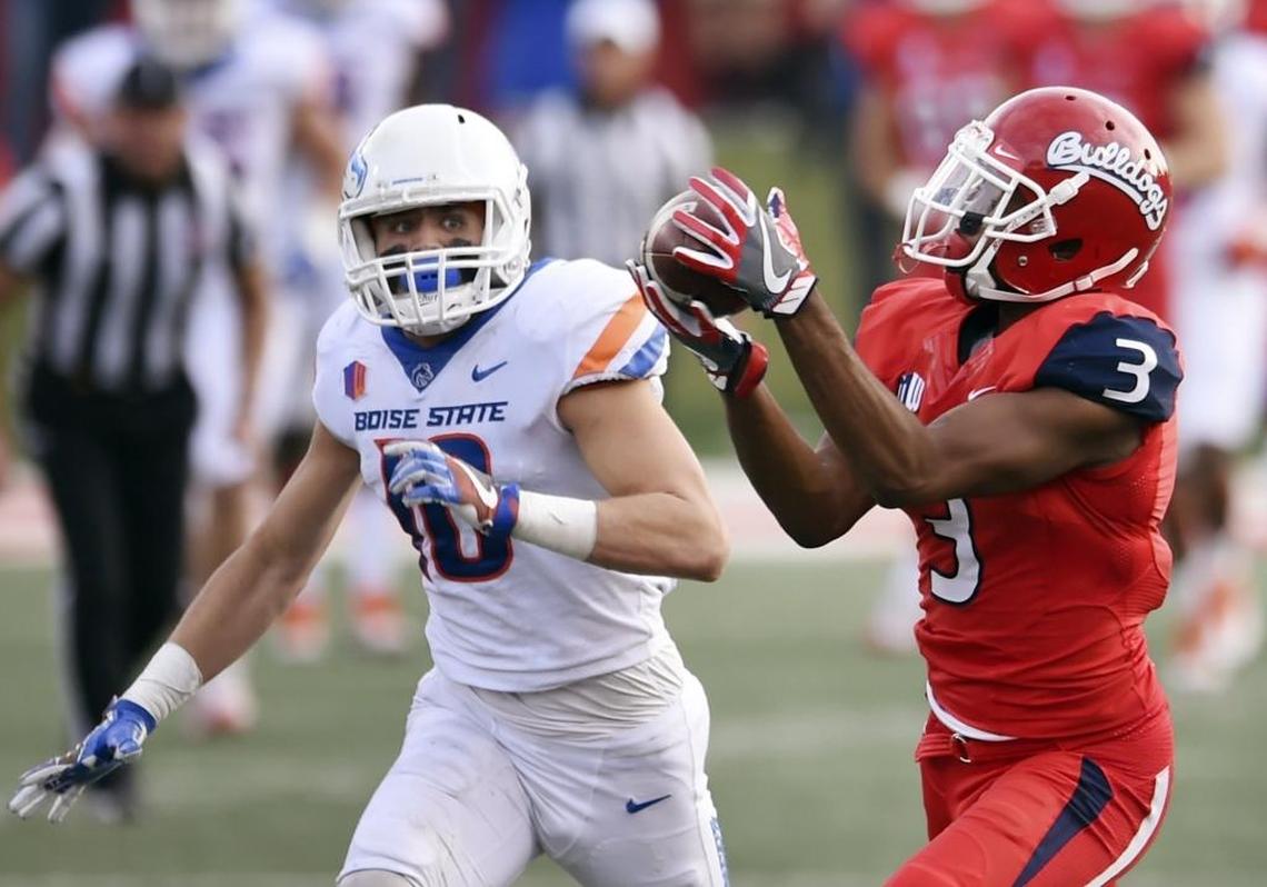 Fresno State’s KeeSean Johnson, right, makes the catch for a touchdown covered by Boise State’s Kekoa Nawahine, left, during second half action Saturday, Nov. 25, 2017 in Fresno. Fresno State Won 28-17.