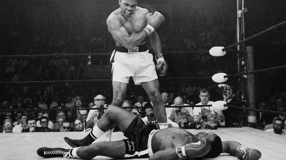 Muhammad Ali fought Sonny Liston twice, first earning the heavyweight title in February 1964 when Liston failed to answer the bell to start the seventh round. They met again in May 1965 – with Ali scoring a first-round knockout captured in this iconic photo.