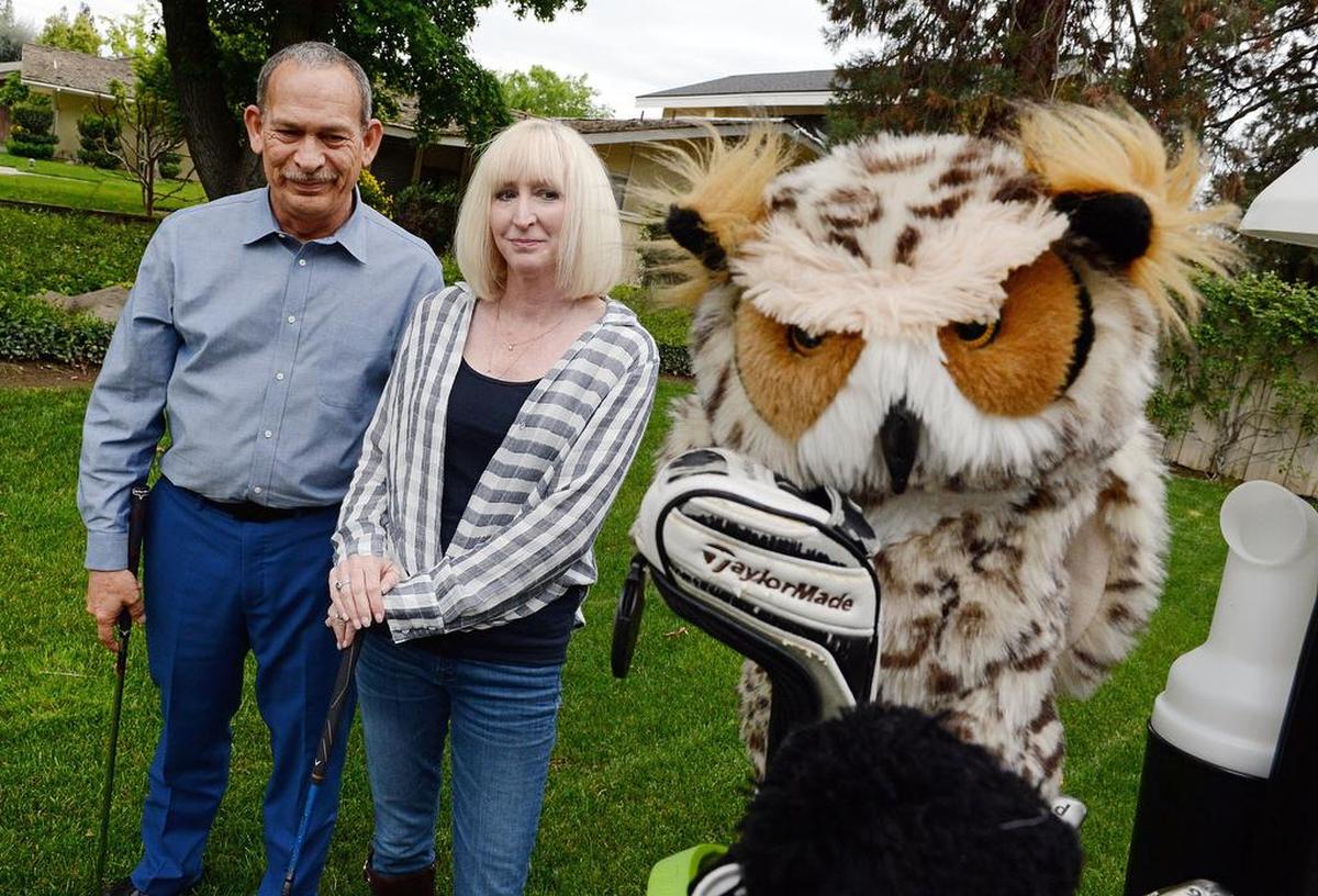 Meredith and Tim Orman stand near their golf cart parked at their home near the San Joaquin Country Club in north Fresno on Thursday, April 6, 2018. The club expelled the couple for challenging and then going public about club rules.