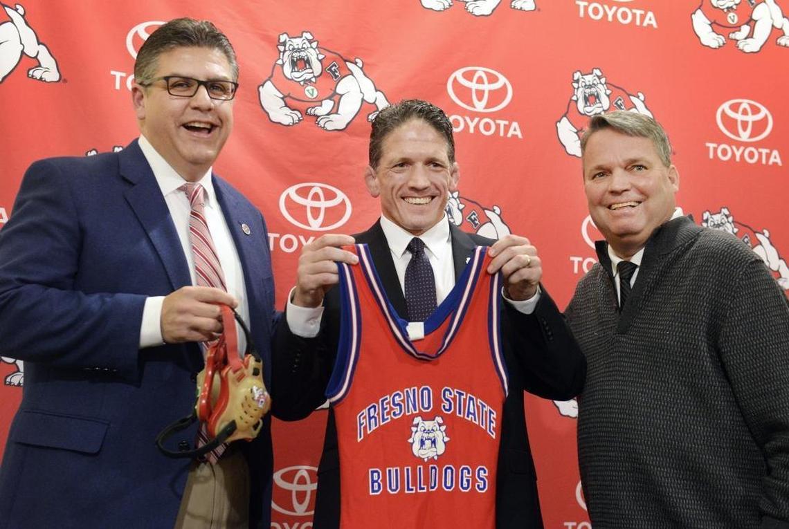 Bulldogs wrestling coach Troy Steiner, center, is flanked by Fresno State President Joseph Castro, left, and former Athletic Director Jim Bartko during a May 2016 press conference. The additions of wrestling and women’s water polo, while popular in the community, place additional strain on department finances.