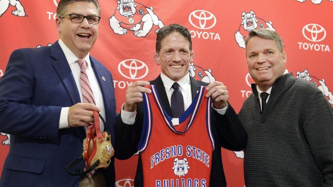Bulldogs wrestling coach Troy Steiner, center, is flanked by then-Fresno State President Joseph I. Castro, left, and then-Athletics Director Jim Bartko during a May 2016 press conference when the sport was reintroduced.
