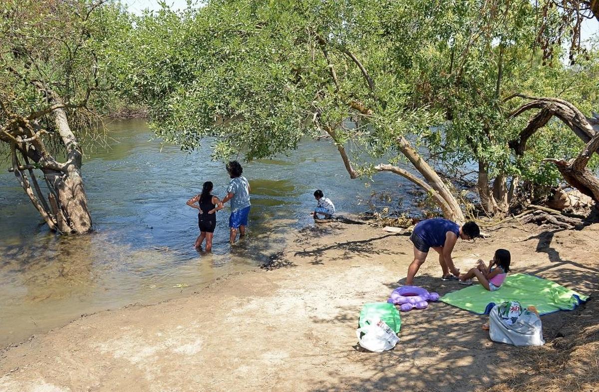 A family cools off in the San Joaquin River, accessed from the Jensen River Ranch north of Woodward Park. The 156-acre area, owned by the San Joaquin River Conservancy, is one of the few places in Fresno where this is possible without trespassing.