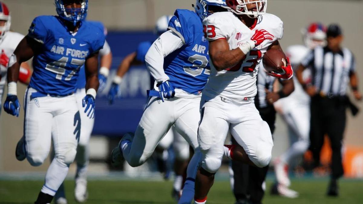 Fresno State running back Marteze Waller runs for a 64-touchdown, racing past Air Force linebackers Claude Alexander III, back left, and D.J. Dunn Jr. in the first half of Saturday’s game. The Bulldogs broke on top 14-0, but Air Force stormed back to take a 21-14 lead at halftime.