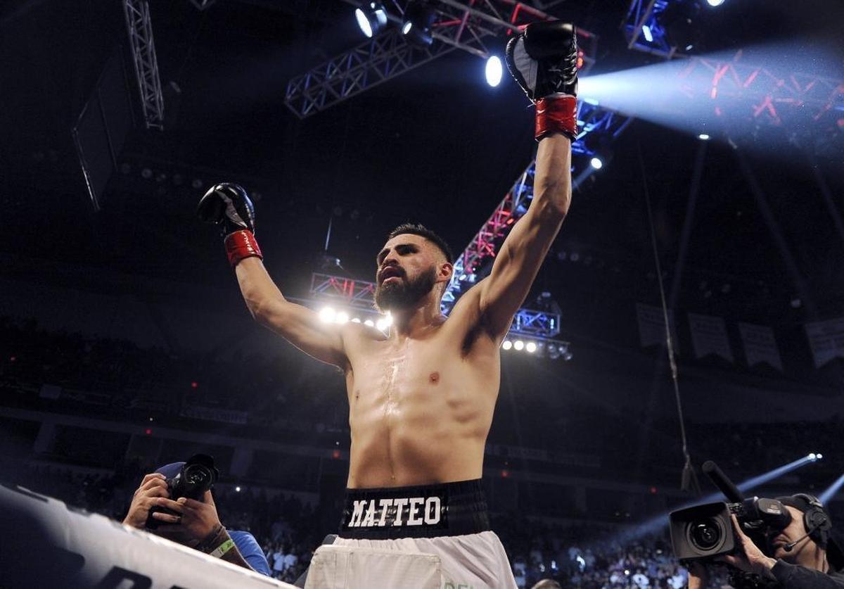 Avenal’s Jose Ramirez climbs a corner post raising his arms to the crowd after winning his bout against Michael Reed in two rounds by TKO at Fight For Water 7, held Saturday, Nov. 11, 2017 in Fresno.