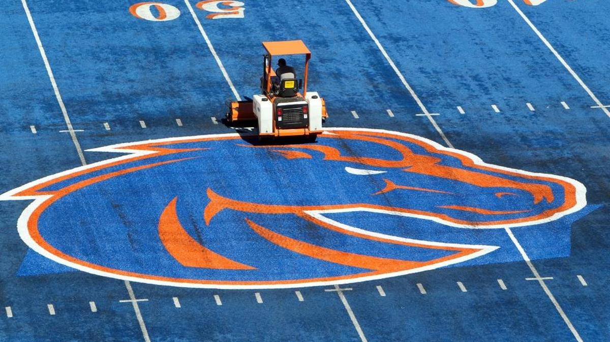 A crew member works on the Boise State logo at midfield of Albertsons Stadium, site of Saturday’s Mountain West Conference championship game between Fresno State and Boise State.