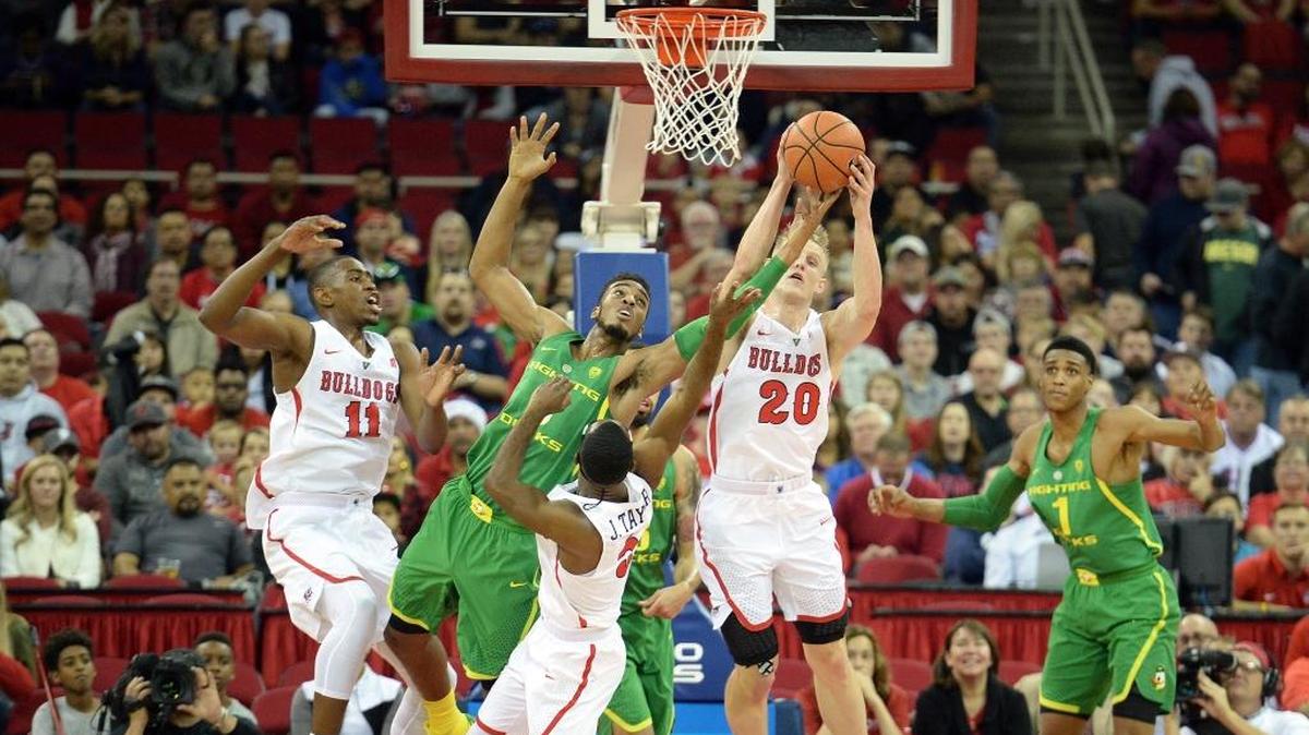 Fresno State’s Bryson Williams, from left, Jahmel Taylor and Sam Bittner try to steal the ball away from Oregon’s Troy Brown during their game at the Save Mart Center in Fresno on Saturday, Dec. 16, 2017.