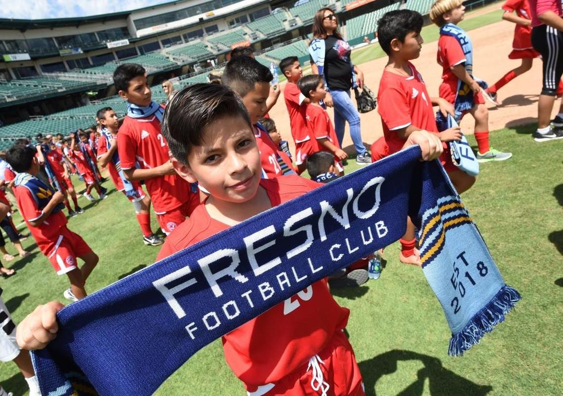 Ten-year-old Jonathan Molina, Madera Magic Soccer Club member, proudly shows his Fresno FC scarf after Wednesday’s press event at Chukchansi Park formally announcing the new USL team.