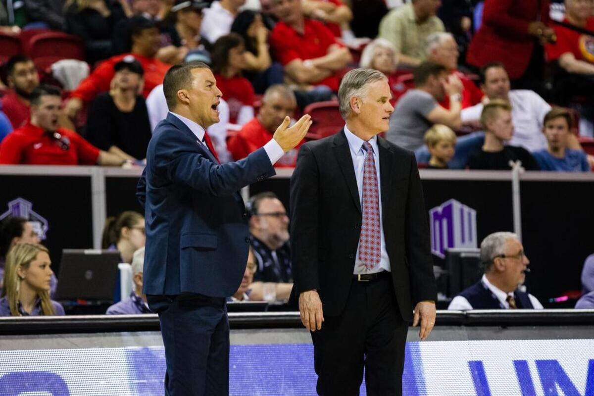 San Diego State associate head coach Justin Hutson, left, stands alongside head coach Brian Dutcher during a game this season at Viejas Arena. Hutson is among those who have interviewed for the Fresno State coaching vacancy.