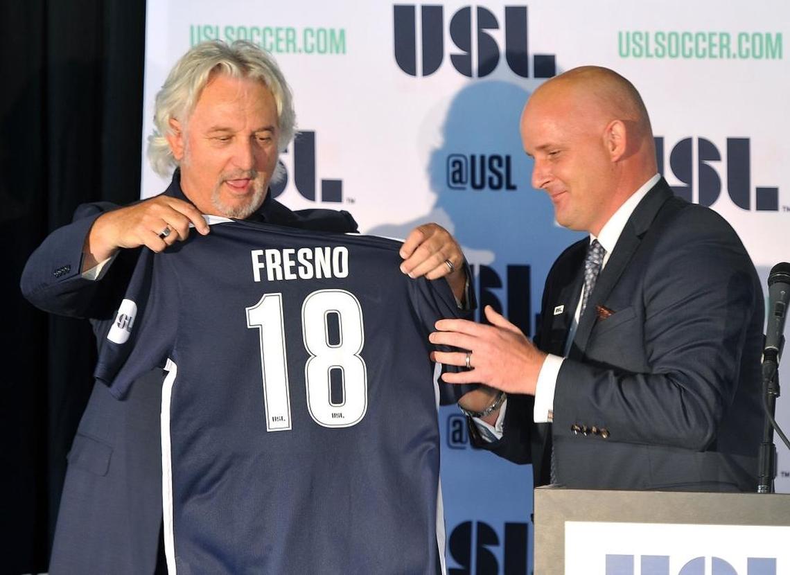United Soccer League president Jake Edwards, right, receives a 2018 jersey from Fresno FC owner Ray Beshoff during a news conference officially announcing the expansion franchise Wednesday at Chukchansi Park.