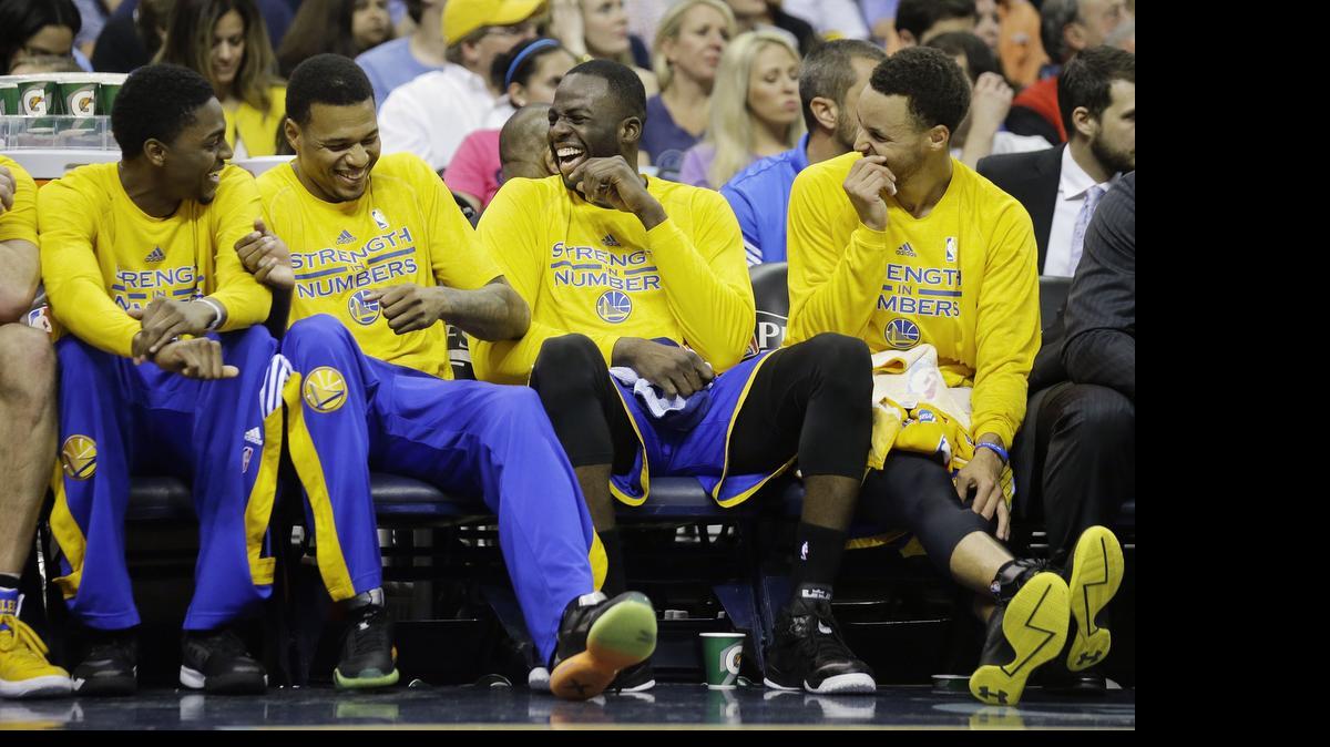 
Warriors players, including (from left) Justin Holiday, Brandon Rush, Draymond Green and Stephen Curry, yuck it up on the bench during Golden State’s Game 6 victory over Memphis. The Western Conference finals against Houston should also be a laugher.
