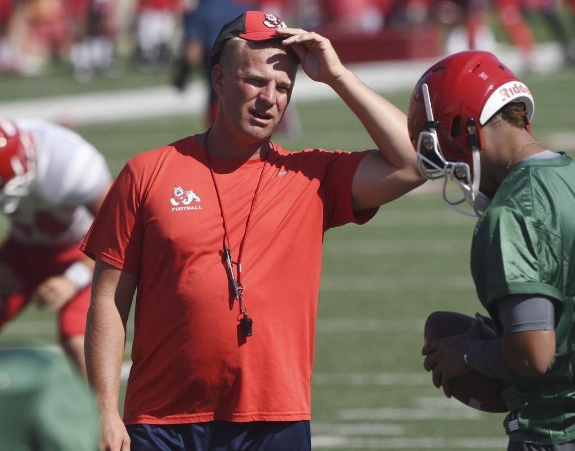 Fresno State offensive coordinator Kalen DeBoer, left, stands with Marcus McMaryion before a preseason scrimmage at Bulldog Stadium.