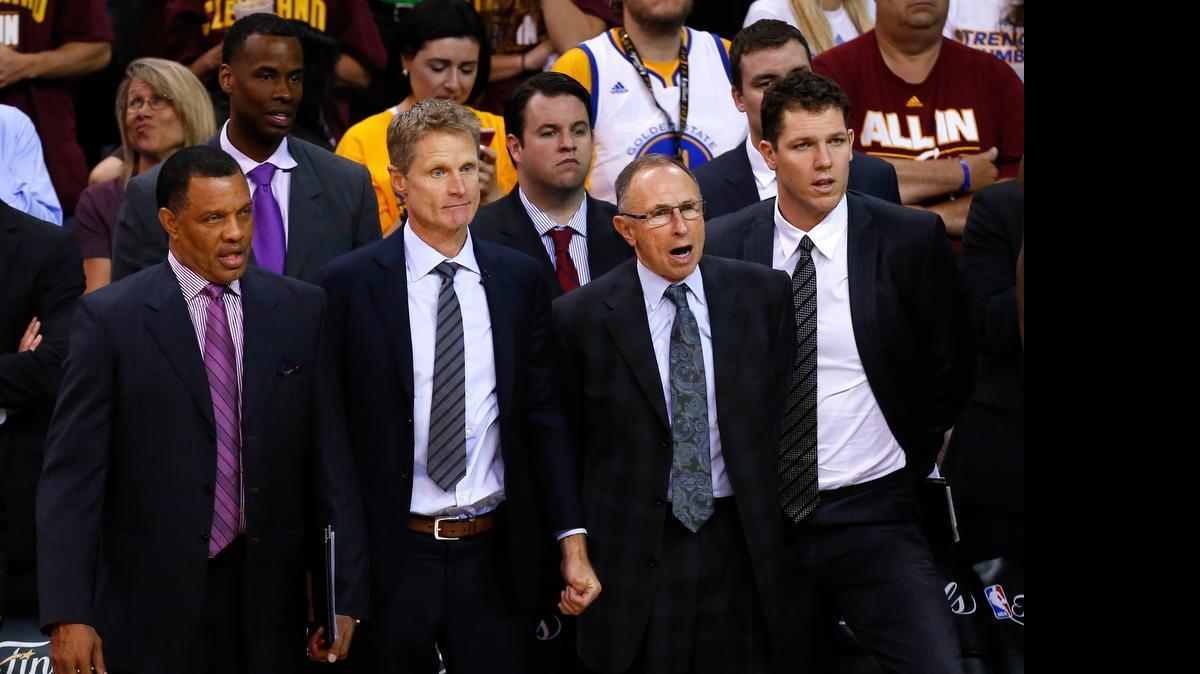 
Golden State’s run to the NBA championship in Steve Kerr’s rookie season as coach was fueled by star players but also helped along by a strong staff of assistants. From left, Alvin Gentry, Kerr, ex-Fresno State coach Ron Adams and Luke Walton watch June 16 as the Warriors finish off Cleveland 105-97 to win the best-of-seven game finals series 4-2.
