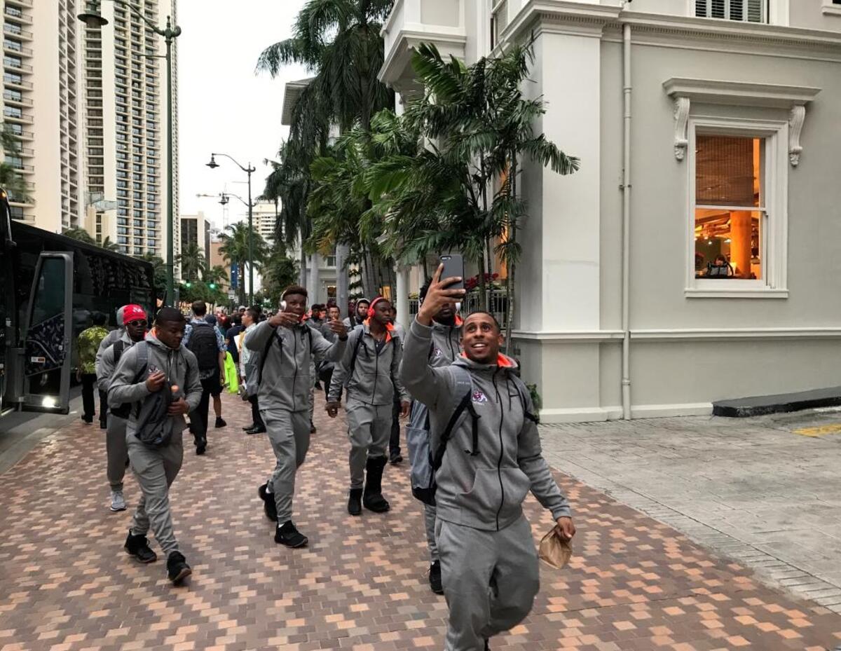 Senior Austin Harper uses his phone to capture the sights and sounds of Waikiki after the Fresno State Bulldogs arrived at their team hotel for Sunday’s Hawaii Bowl.