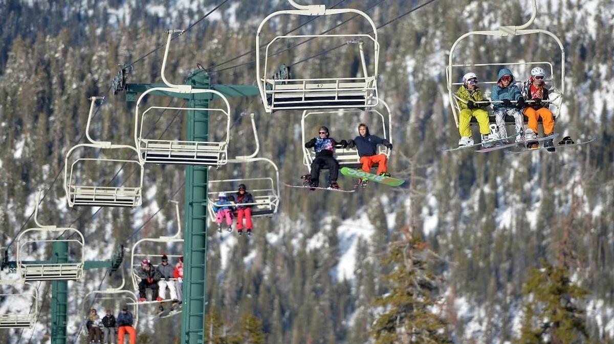 Snowboarders and skiers ride a chairlift up the mountain at China Peak, located 65 miles east of Fresno, Calif., in the Sierra National Forest.