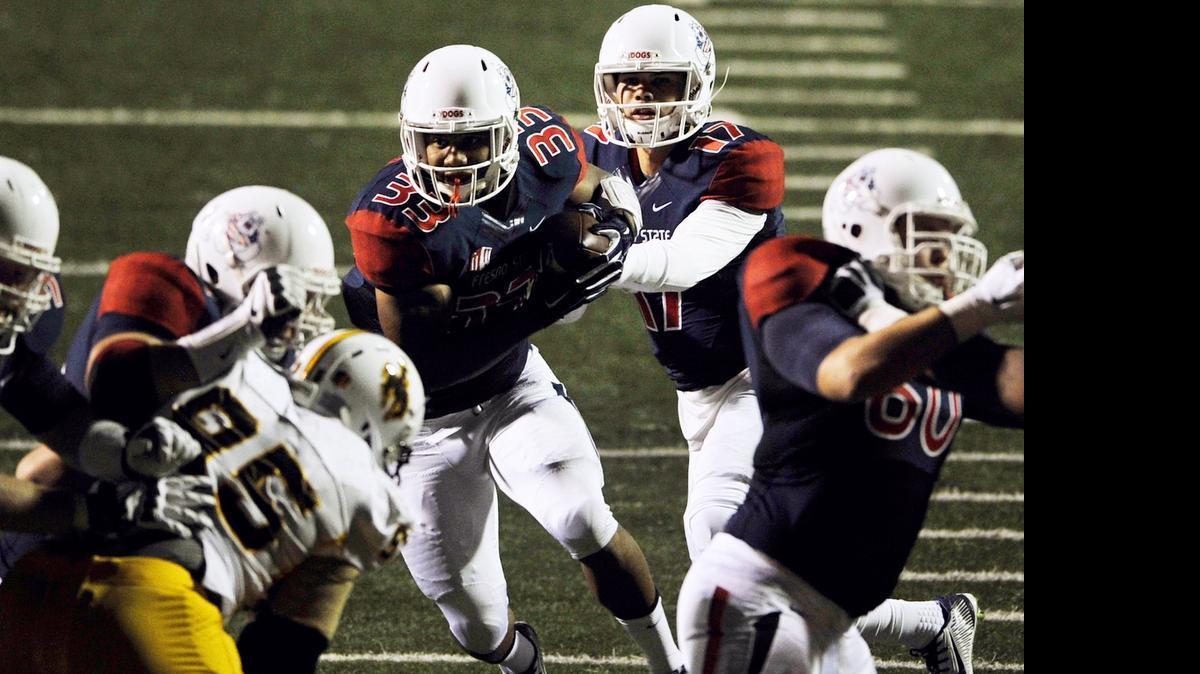 
Fresno State running back Marteze Waller, center, will be the cornerstone of the Bulldogs offense this season, but it remains to be seen if it’s Zack Greenlee who will be the one handing off to him. That question will be answered soon as players report to fall camp Aug. 5.
