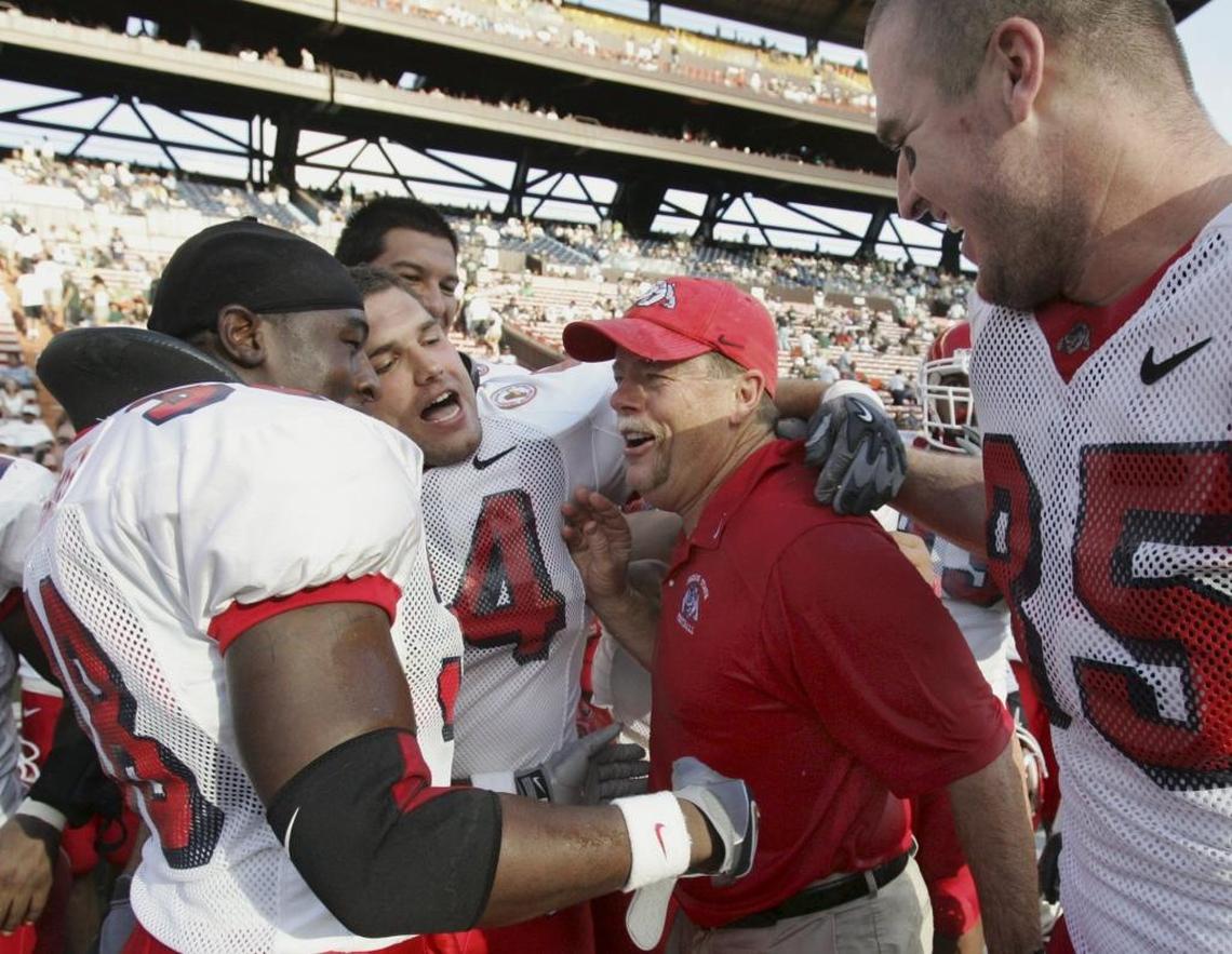 Fresno State football coach Pat Hill is congratulated by his players following a 2005 victory over Hawaii at Aloha Stadium.
