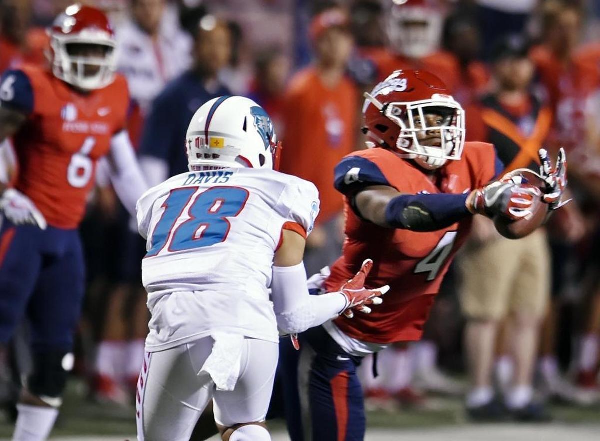 Fresno State’s Mike Bell, right, dives and nearly picks off a pass intended for New Mexico’s Chris Davis Jr. in the second half of Saturday’s 38-0 blowout.