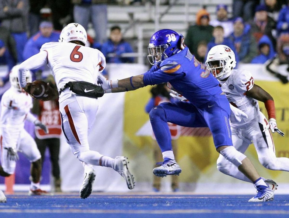 Fresno State quarterback Marcus McMaryion slips through the grasp of Boise State linebacker Leighton Vander Esch during the first half of Saturday’s Mountain West championship in Boise, Idaho.