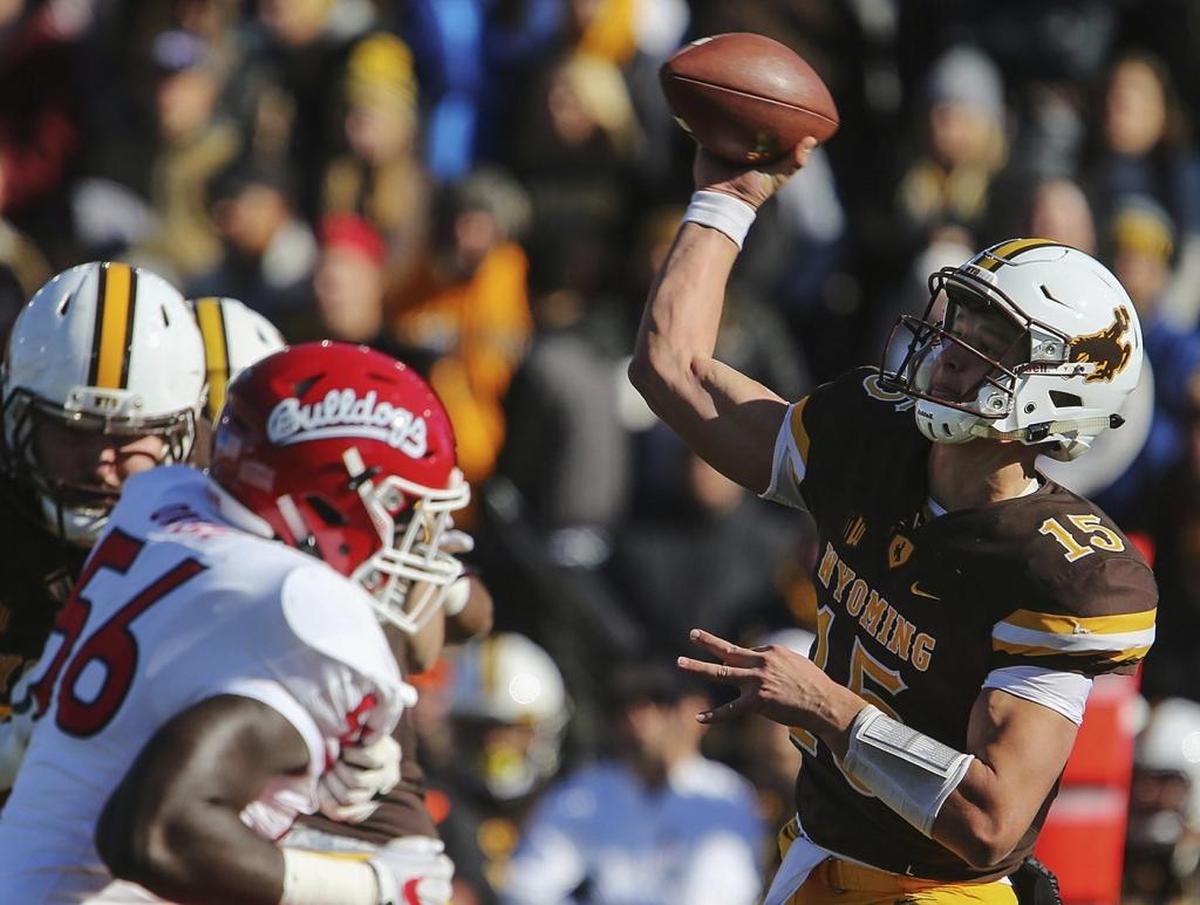 Fresno State defensive end Tobenna Okeke pressures Wyoming quarterback Nick Smith, who was forced into action when starter Josh Allen couldn’t play because of a shoulder injury suffered last week.
