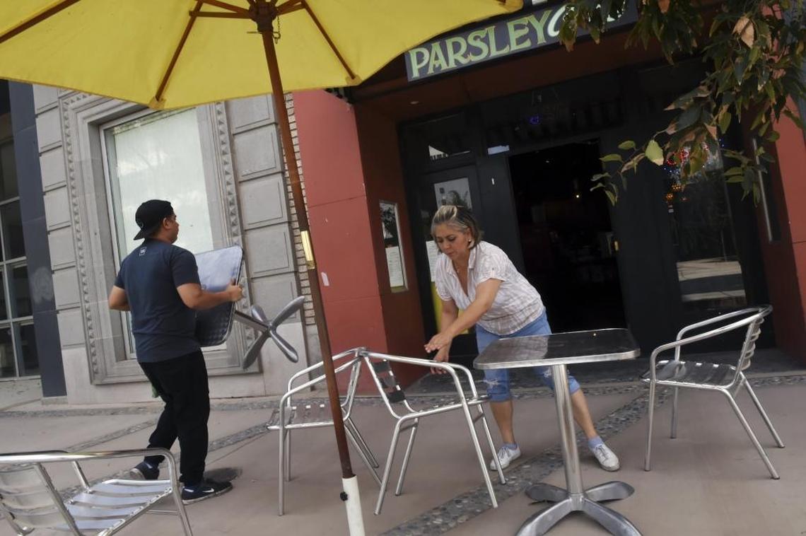 Parsley Garden Cafe co-owner Blanca Partida and her 21-year-son Alex close up shop Monday afternoon after another slow day. Since construction began outside the cafe’s front door for the reopening of Fulton Street, business has declined nearly 70 percent.