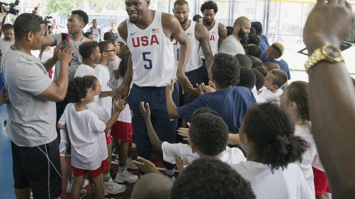 Kevin Durant – the hottest NBA free agent – greets kids as he was introduced with the other 11 members of the U.S. Olympic basketball team in New York on Monday. If Durant chooses to leave the Thunder to join the Warriors this offseason, it could be game over for the rest of the NBA.