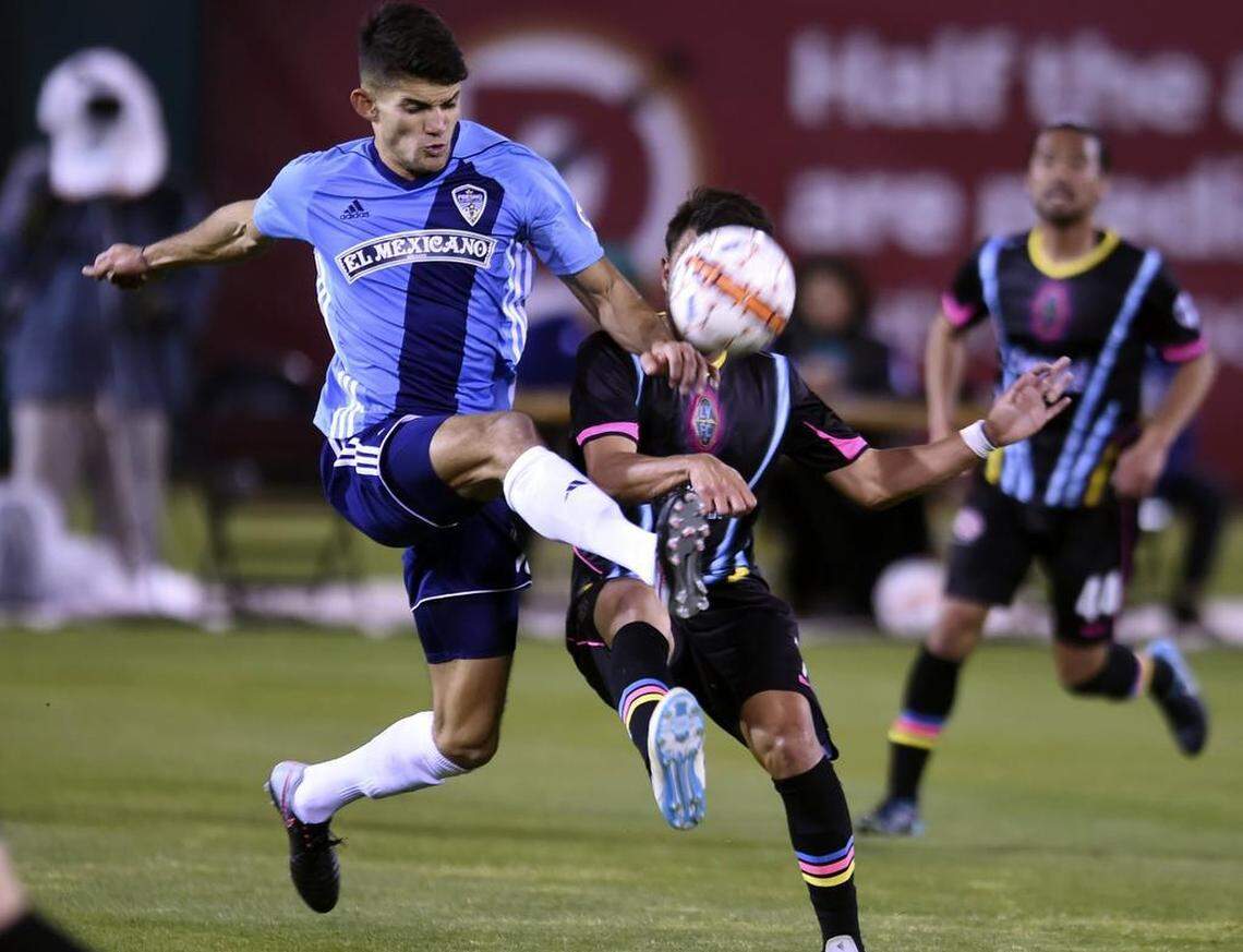 Fresno Football Club’s Alberto “Beto” Navarro, front, attacks Las Vegas Lights FC’s Carlos Alvarez, background, Saturday, March 17, 2018 in Fresno. Las Vegas triumphed over Fresno 3-2.