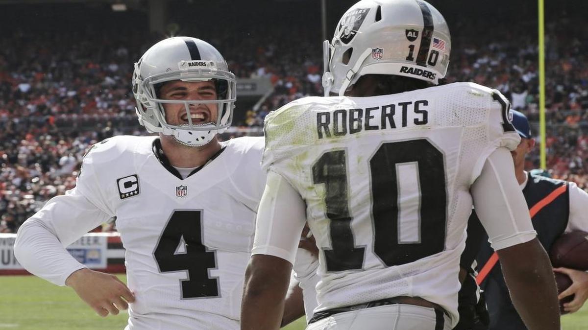 
The Raiders’ Derek Carr celebrates after wide receiver Seth Roberts, right, scored on a 13-yard reception during the first half against the Browns on Sunday. Carr has led the Raiders to back-to-back wins for the first time since taking over as the starting quarterback prior to his rookie season in 2014.
