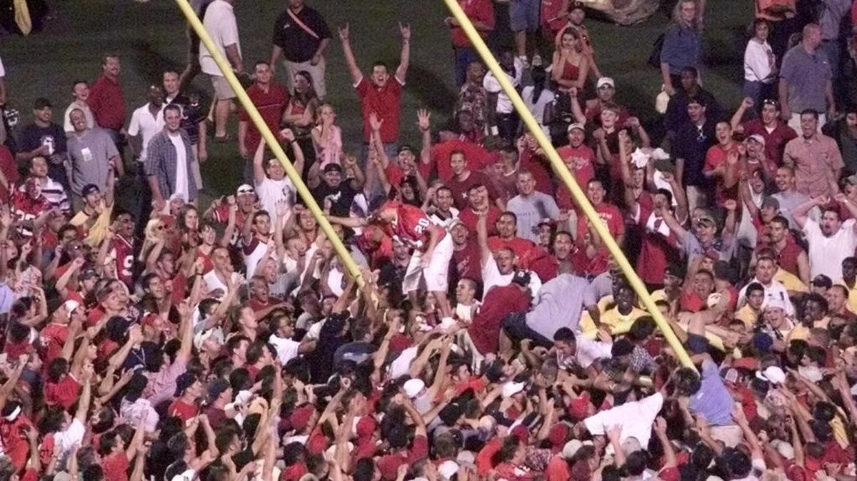 Fresno State fans rush the field and tear down the goalpost in the north end zone at Bulldog Stadium following Fresno State’s 44-24 upset of No. 10 Oregon State on Sept. 2, 2001.