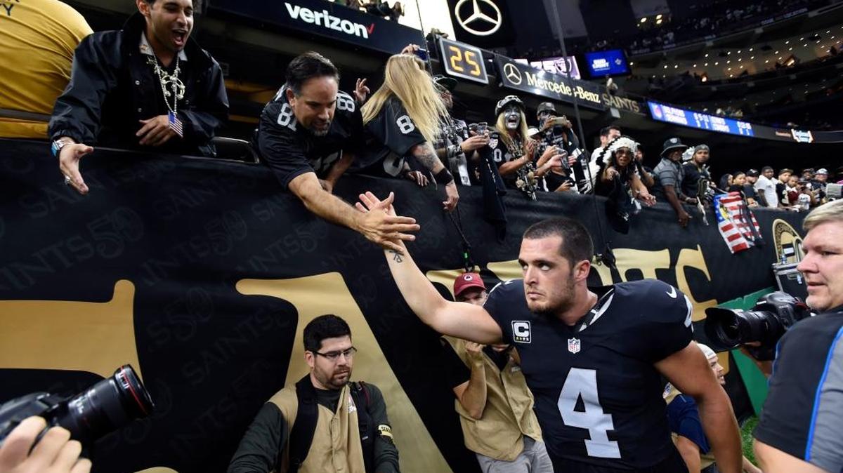 Derek Carr high-fives fans on his way out of the Superdome on Sunday afternoon following the Oakland Raiders’ dramatic 35-34 season-opening victory over the New Orleans Saints.