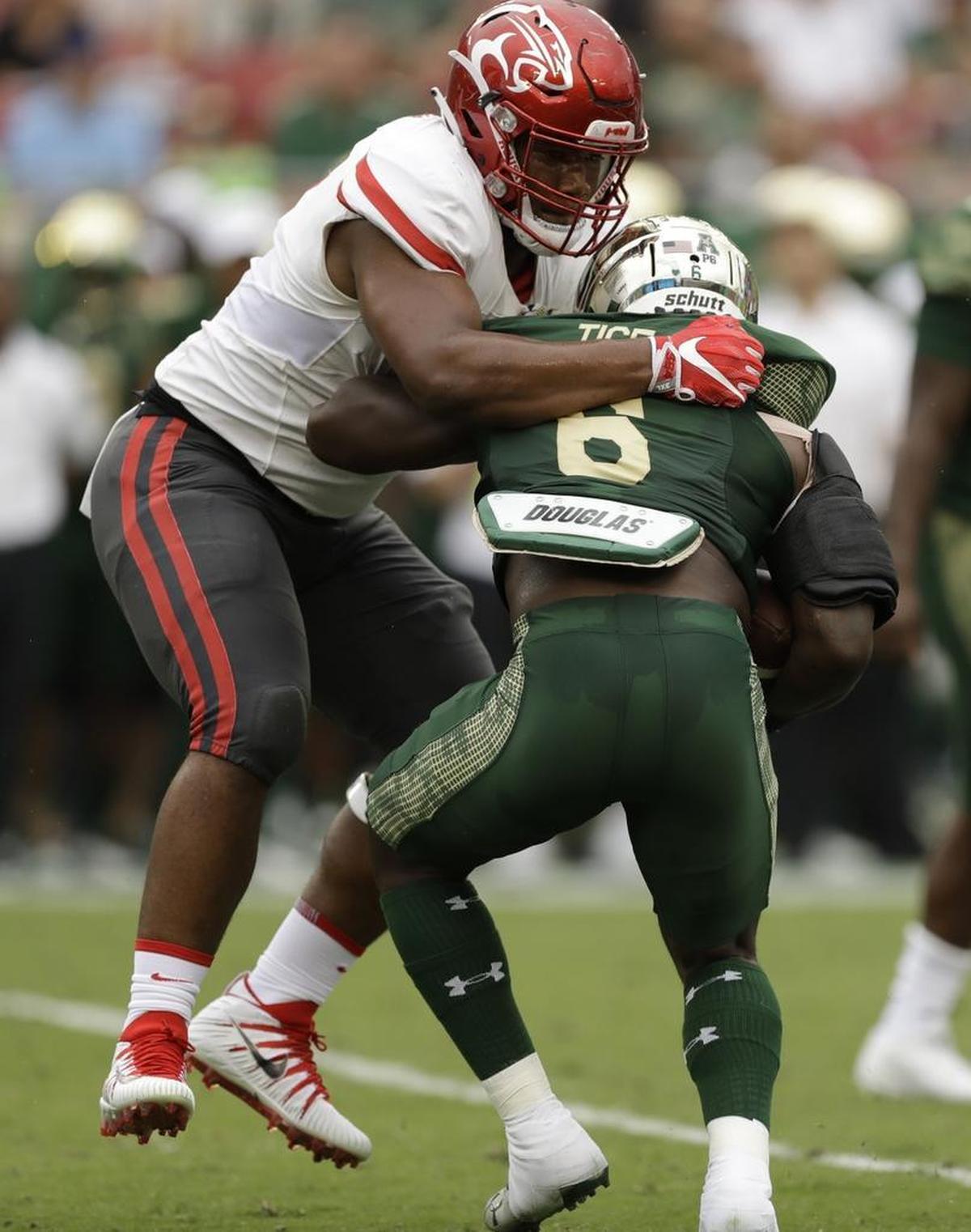 Houston defensive tackle Ed Oliver corrals South Florida running back Darius Tice (6) during their game in Tampa, Fla., on Oct. 28, 2017.