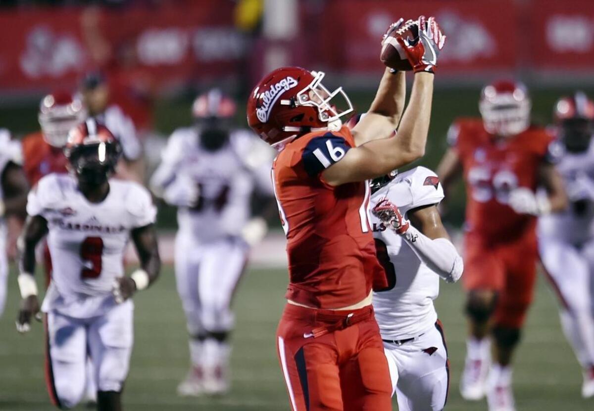 Fresno State tight end Jared Rice hauls in a 65-yard touchdown thrown by Josh Hokit on a halfback pass. The Bulldogs’ longest offensive play of the night made the score 17-0 in the first quarter.