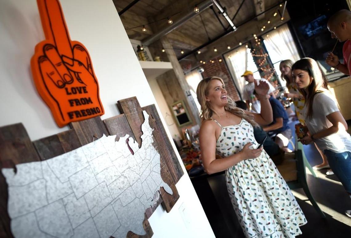 Jordan Gustafson, center, hosts a pregame party in her Pacific Southwest Building loft before a 2017 Fresno Grizzlies game. 