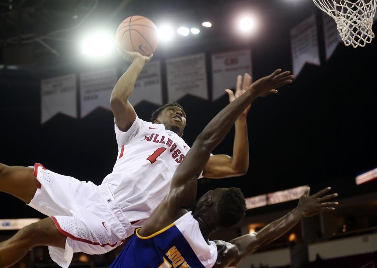 Fresno State’s Jaron Hopkins, top, collides with Cal State Bakersfield’s Fallou Ndoye on an acrobatic drive to the bucket during a nonconference game at Save Mart Center on Dec. 5, 2017.