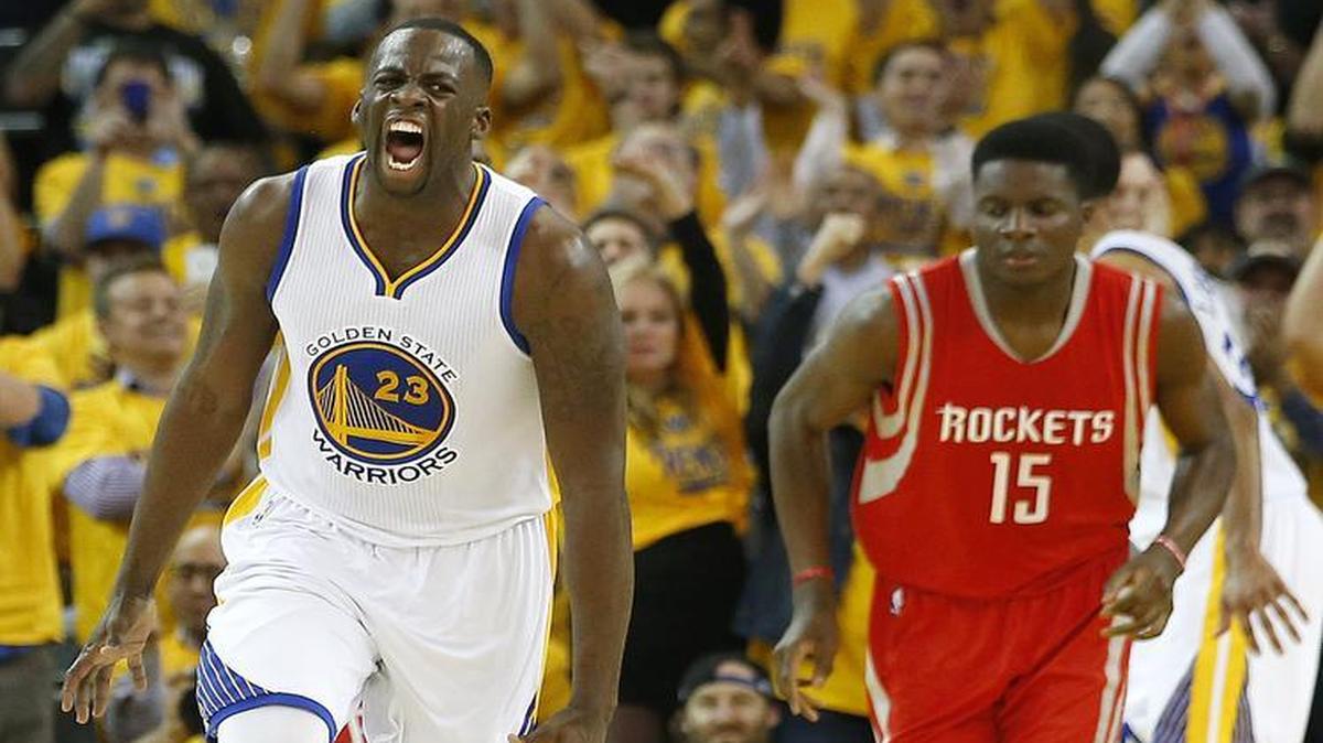 
Golden State Warriors forward Draymond Green (23) reacts after scoring, in front of Houston Rockets center Clint Capela (15) during the first half of Game 1 of the NBA basketball Western Conference finals in Oakland, Calif., Tuesday, May 19, 2015. 
