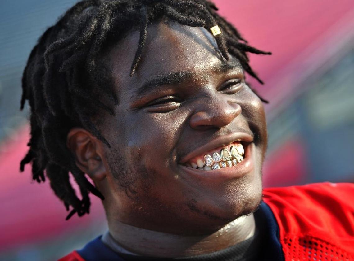 Fresno State defensive tackle Malik Forrester shows off his shiny new grill after a recent practice as the Bulldogs prepare for the Hawaii Bowl on Christmas Eve.
