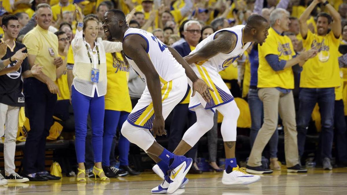 Golden State’s Draymond Green, left, celebrates with teammate Andre Iguodala after a score during the second half in Game 2 of a second-round NBA basketball playoff series against the Portland Trail Blazers on Tuesday, May 3, 2016, in Oakland, Calif. Golden State won 110-99.