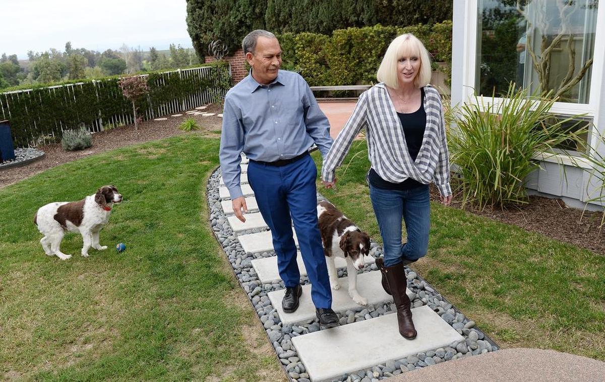 Meredith and Tim Orman spend some time with their dogs in the backyard of their home near the San Joaquin Country Club in north Fresno on Thursday, April 6, 2018. The club expelled the couple for challenging and then going public about club rules.