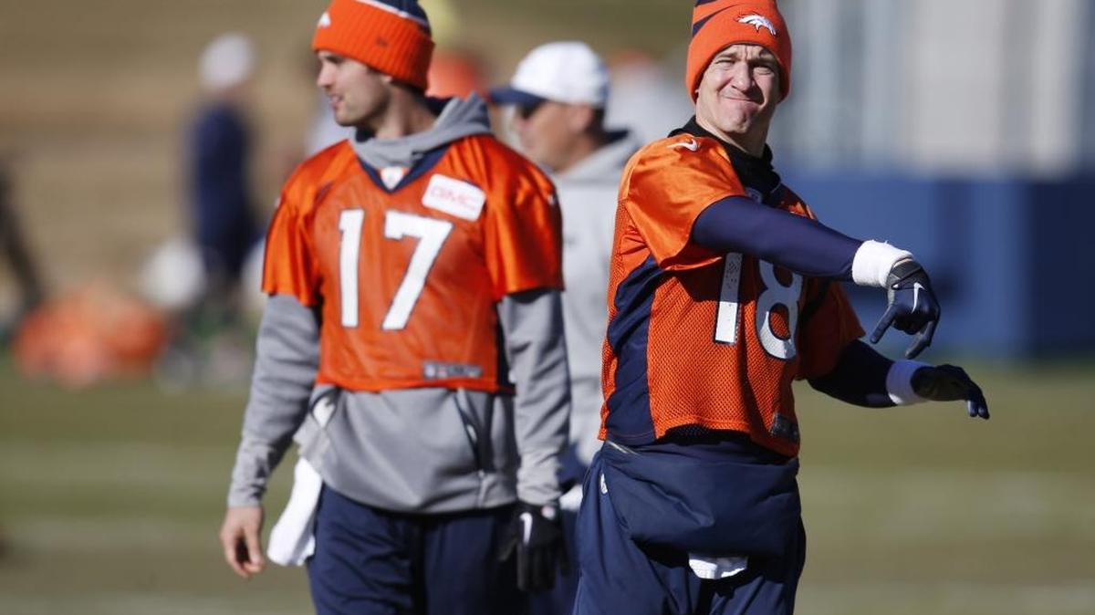Is Peyton Manning, right, a better quarterback than Brock Osweiler (17) at this stage of their careers? It’s a question that has dogged the Denver Broncos all season. Manning may need a turn-back-the-clock performance in Sunday’s AFC Champioship to reach his fourth career Super Bowl.