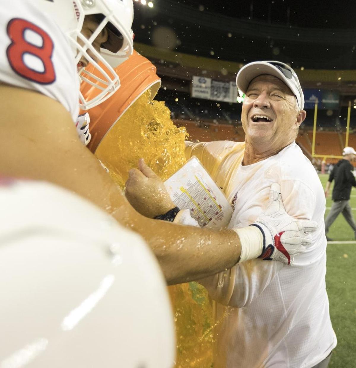 Fresno State coach Jeff Tedford gets showered with sports drink following the Bulldogs’ 33-27 victory over Houston at the Hawaii Bowl on Dec. 24, 2017, in Honolulu.