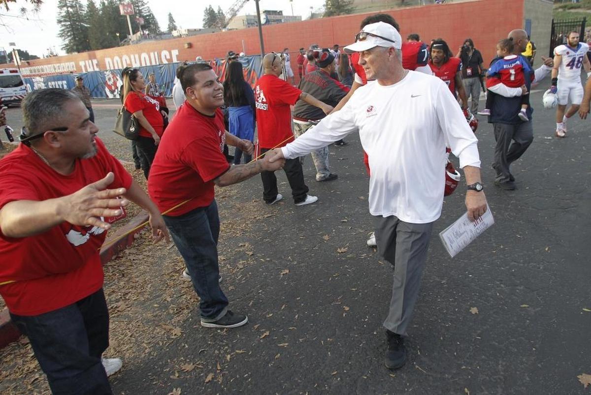 Fresno State coach Jeff Tedford gets congratulated following the Bulldogs’ 28-17 victory over Boise State on Saturday, Nov. 25, 2017.