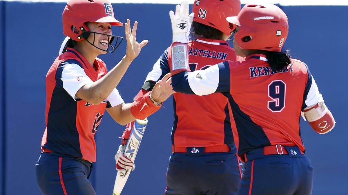 Fresno State’s Christina Rodriguez, left, celebrates scoring a run with teammates Bria Kennedy, right, and Katie Castellon during a 2-1 victory over Utah State on April 17. The Bulldogs are averaging six runs a game, which would be a program record.