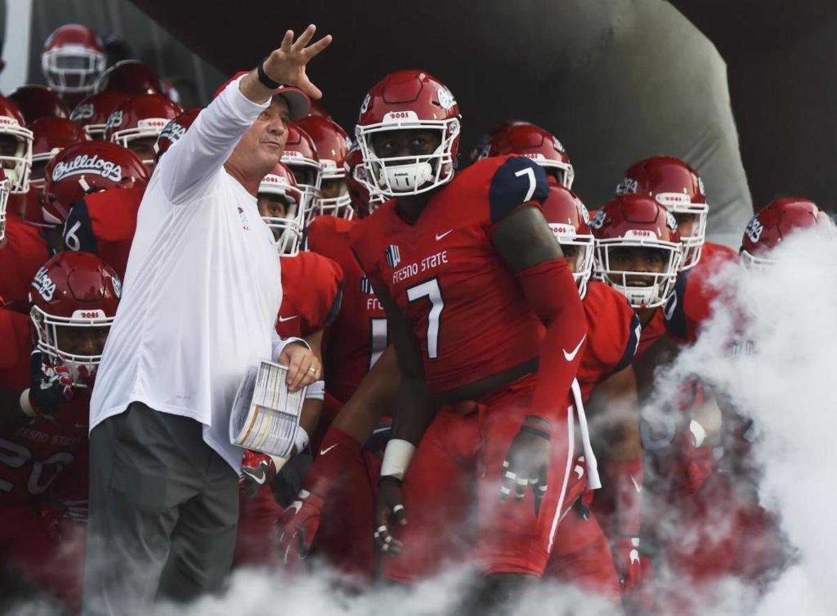 Jeff Tedford directs linebacker James Bailey and the rest of the Bulldogs before his Sept. 2, 2017, Fresno State head-coaching debut against Incarnate Word.