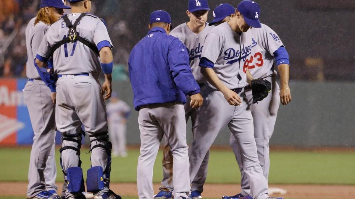 Los Angeles Dodgers starting pitcher Ross Stripling, right, with a no-hitter intact, is pulled from the game by manager Dave Roberts during the eighth inning Friday in San Francisco. Roberts defended the move, saying he did not want to put a young pitcher who already has had Tommy John surgery at risk for a new injury.