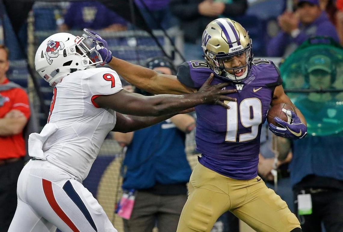 Washington’s Hunter Bryant tries to fend off Fresno State’s Jeffrey Allison as he runs after a pass reception for 50 yards in the first half Saturday, Sept. 16, 2017, in Seattle.