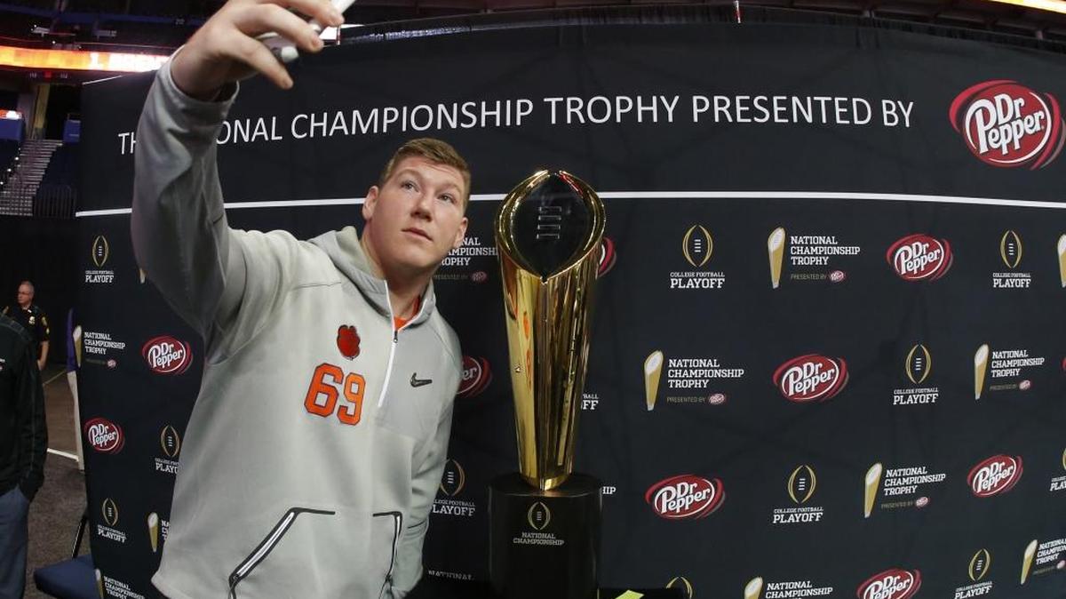 Clemson’s Maverick Morris takes a selfie with the national championship trophy during media day leading up to Monday night’s College Football Playoff championship game against Alabama.