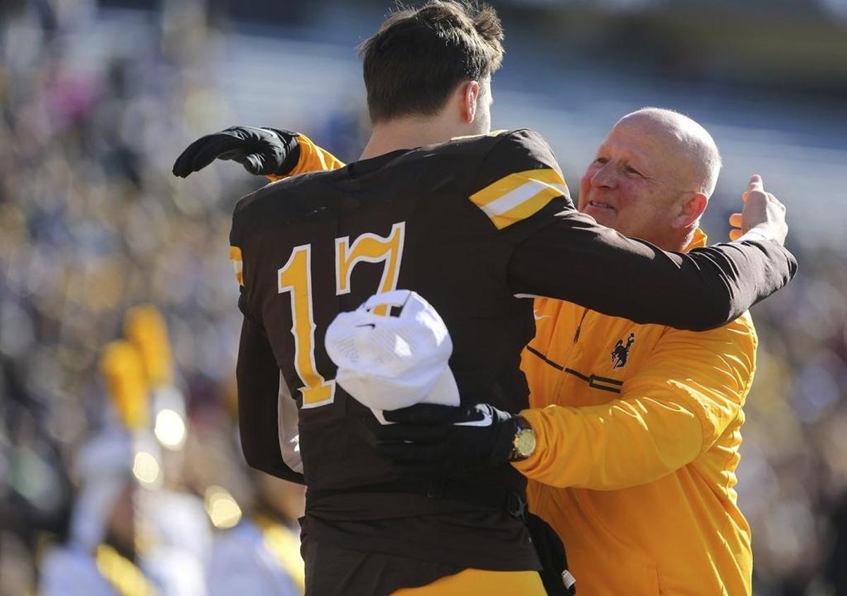 Wyoming coach Craig Bohl hugs quarterback Josh Allen before Saturday’s game against Fresno State. Allen, the Firebaugh native and projected NFL first-round pick, sustained a shoulder injury in Wyoming’s Nov. 11 victory over Air Force. Allen, a junior, suited up for the game and took part in the pregame Senior Day ceremony. Which is a pretty good indication the 6-foot-5, 240-pounder plans to declare for the draft.