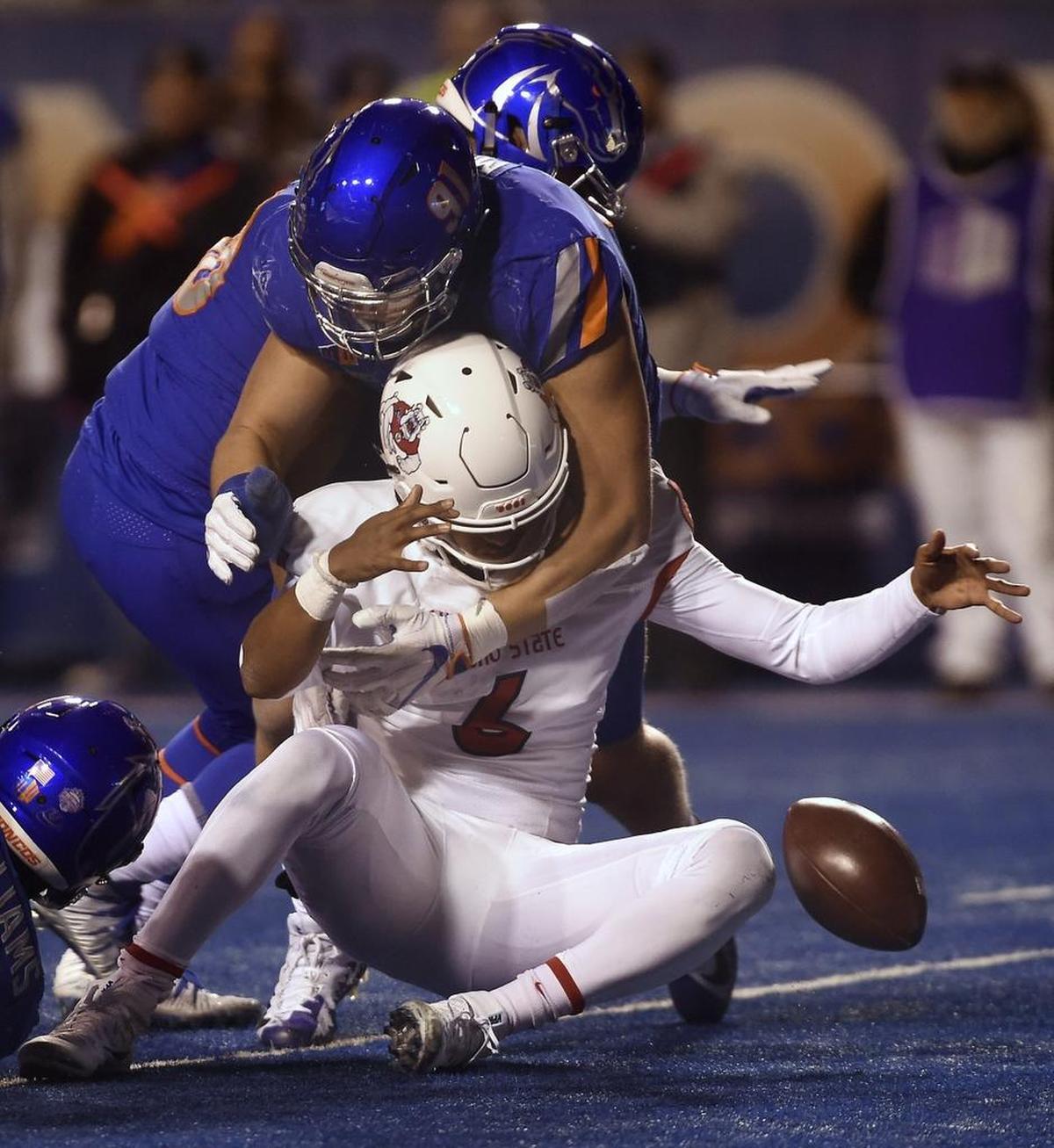 Fresno State quarterback Marcus McMaryion loses the ball as Boise State defensive end Durrant Miles sacks him in the third quarter. McMaryioin recovered the fumble.