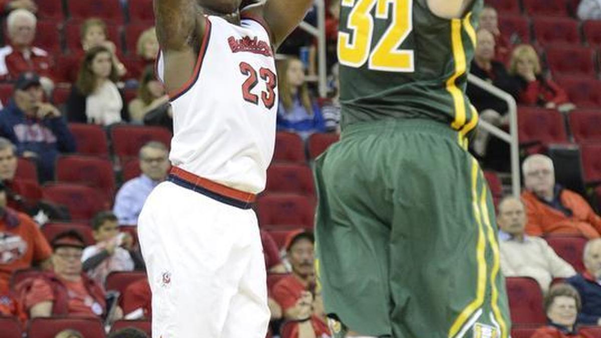 Fresno State’s Marvelle Harris takes a three-point shot while defending by San Francisco’s Tim Derksen on Nov. 19, 2015, at Save Mart Center. Harris is shooting 27.4 on three-pointers this season, well off last year’s 32.1 not to mention his 35.9 rate from 2013-14.